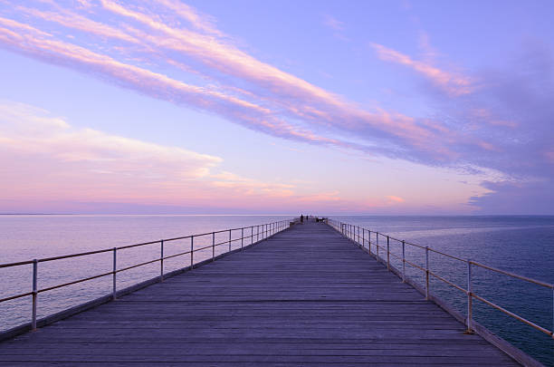 istock Wooden jetty at dusk with clouds in the sky 503396008