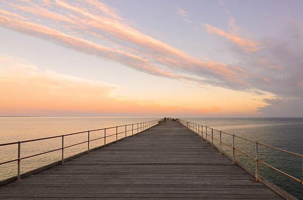 istock Wooden jetty at dusk with clouds in the sky 503396240
