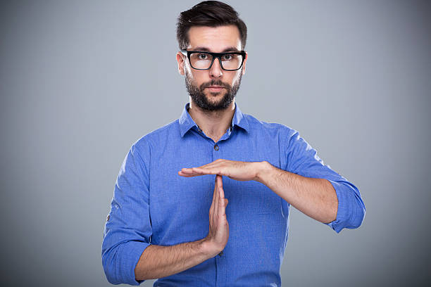 Man showing time out gesture Man showing time out gesture time out signal stock pictures, royalty-free photos & images