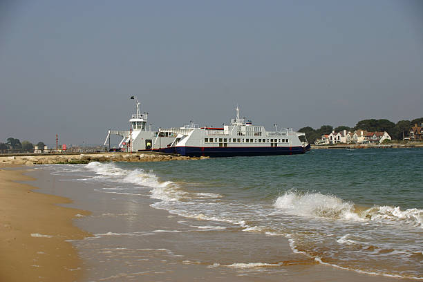 Sandbanks to Studland ferry A chain ferry crossing from Sandbanks to Studland in Dorset. Side view of the ferry on Studland with blue sky as background. studland heath stock pictures, royalty-free photos & images