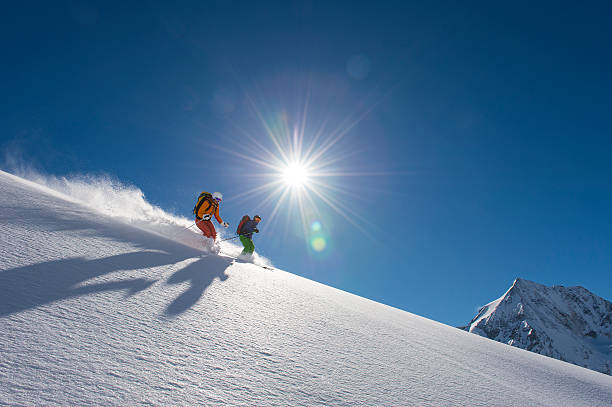istock skitouring downhill - powder skiing 503398902