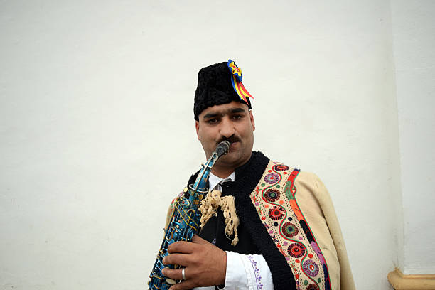 istock Gipsy singing traditional Romanian carols at saxophone. 503399738