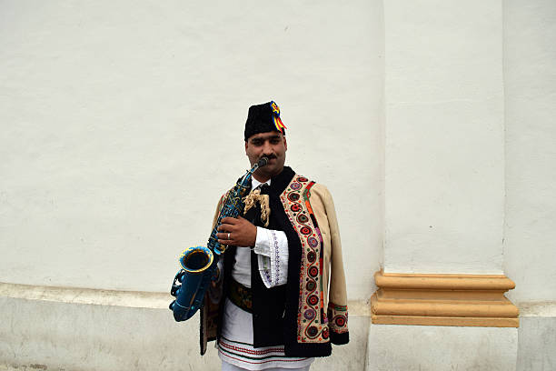 istock Gipsy singing traditional Romanian carols at saxophone. 503399848
