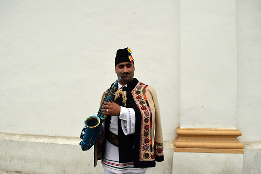 Gipsy, singing traditional Romanian carols at saxophone, in Medias, Romania.