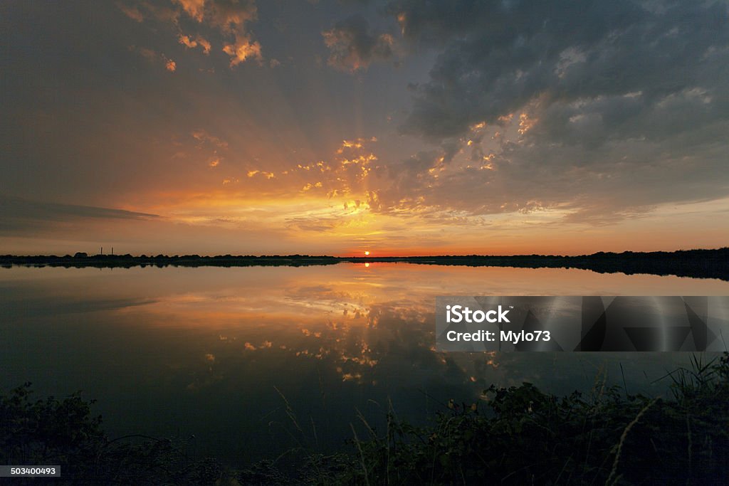 Reflected Sunset Sunset reflected in Cliffe Pools, Kent, UK Cloud - Sky Stock Photo