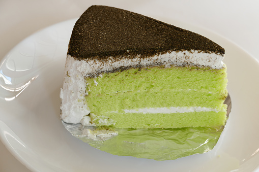 piece of green tea cake on white plate