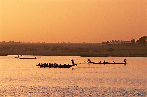 Small wooden canoe floating on the calm waters of Guayas River near Santay Island, creating a serene scene of river navigation and cultural exploration