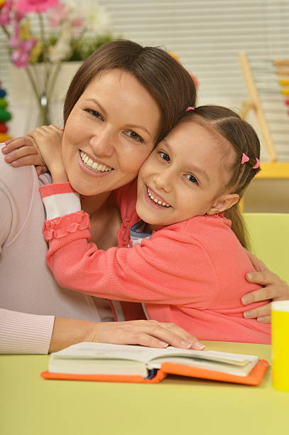 istock Daughter and mother reading the book 503400808