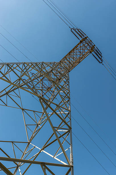 istock High Voltage Electricity Pylon, Power Lines, Day, Blue Sky. Vertical. 503401181