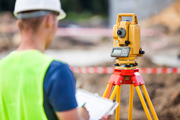 Land Surveyor Land surveyor working with total station. tacheometer stock pictures, royalty-free photos & images