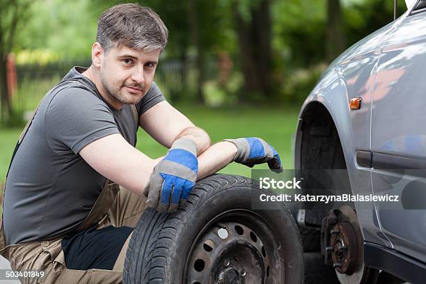 Car Mechanic Working Outdoors Stock Photo - Download Image Now - Adult, Adults Only, Bib Overalls