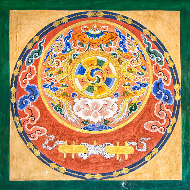 Religious painting in Bhutanese temple Painted dharmacakra in the  Paro Dzong, the famous Bhutanese Monastery.The Mural represents a Dharmacakra, Wheel of dharma,  a chariot wheel with 8 or more spokes. It is one of the oldest known Buddhist symbols. Buthanese religious paintings and statues ore in the public domain.  Bhutanese art is anonymous, religious and as a result it has no aesthetic function by itself. A Bhutanese does not view a painting or a statue as a work of art but as a religious work.  Paintings are not signed, paintings have no copyright.  This is all well explained in Françoise Pommaret’s “Bhutan, Himalayan Mountain Kingdom” edited by Odyssey Books &  guides. dharma stock pictures, royalty-free photos & images