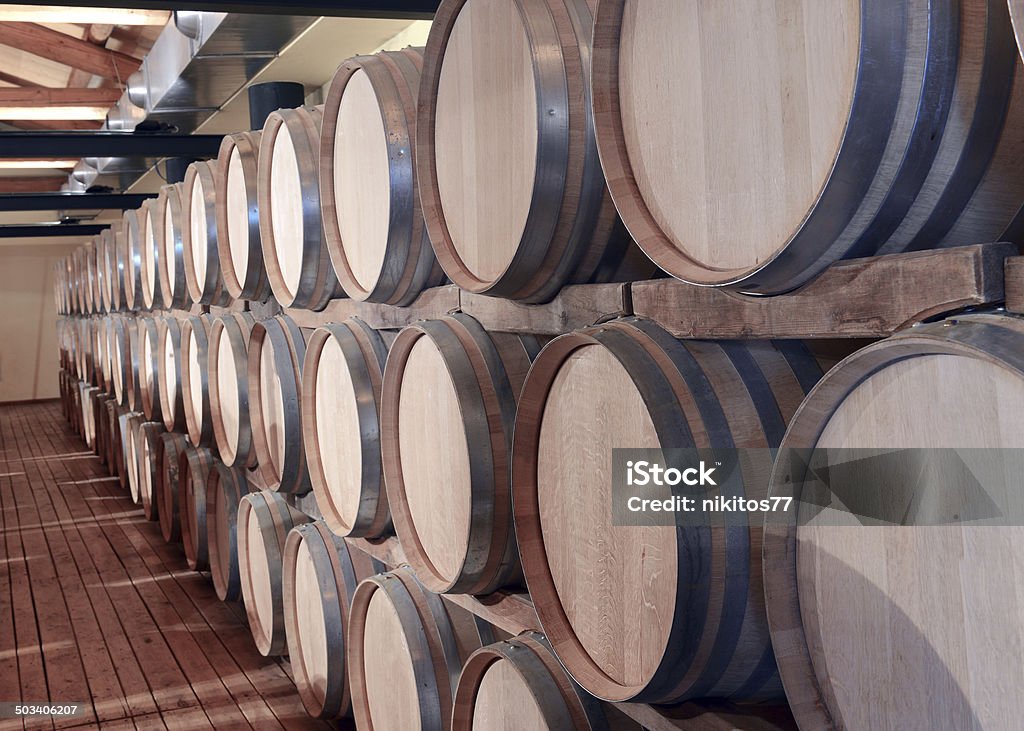 Casks in wine cellar Casks in wine cellar and bottle Alcohol - Drink Stock Photo