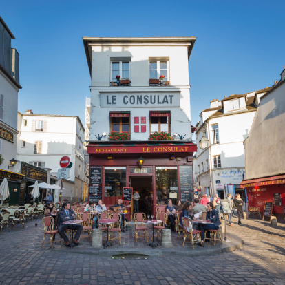Paris, France - May 15, 2014: Le Consulat a typical cafe in Montmartre area, some tourists have relax in the terrace of the bar drinking something.