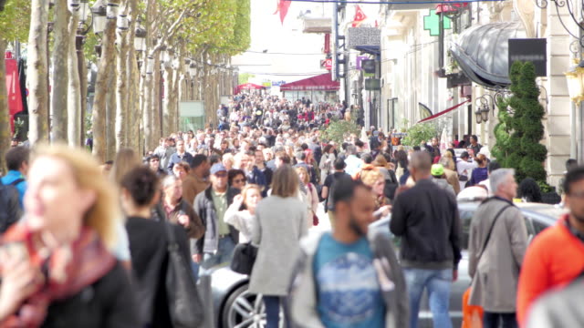 Pedestrians on a crowded avenue in summer