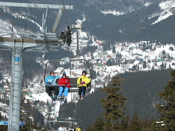 Skiers on a ski lift stock photo