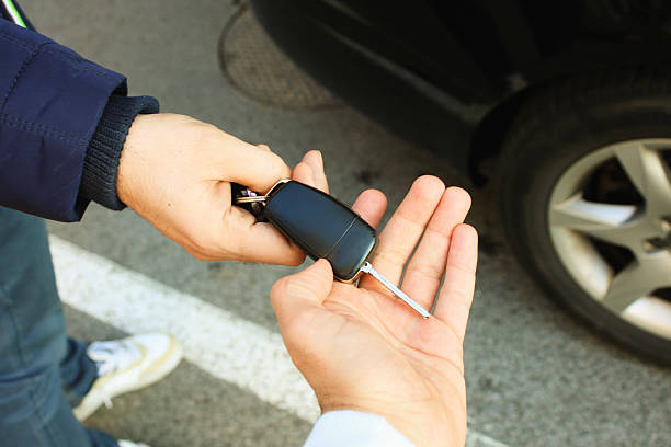 Buyer taking car key Buyer taking car key from seller car for sale stock pictures, royalty-free photos & images