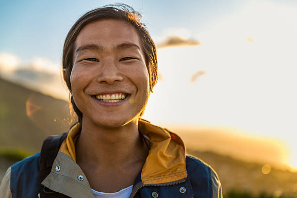 istock Smiling male backpacker on hill during sunset 503415236