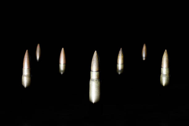 istock Partially illuminated old rifle bullets in the dark 503416852
