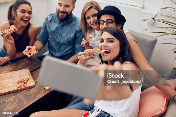 Young People Taking A Selfie While Eating Pizza Stock Photo - Download Image Now - Pizza, Friendship, Eating