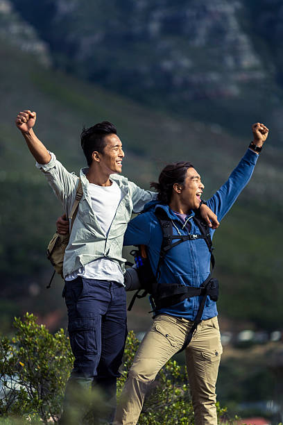 istock Cheerful hikers raising hands on hill 503417196