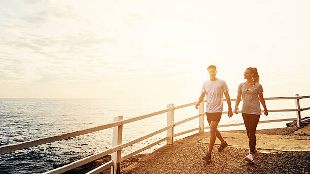 Fresh air and an amazing view Shot of people walking along a path by the coasthttp://195.154.178.81/DATA/i_collage/pu/shoots/806139.jpg sports training australia stock pictures, royalty-free photos & images
