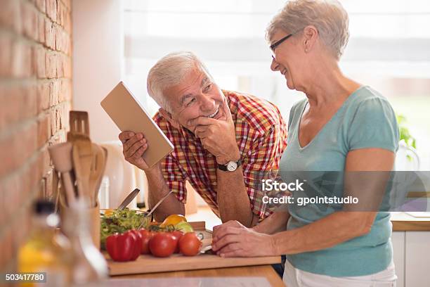 Moderne Senior Paar Verbringen Zeit In Der Küche Stockfoto und mehr Bilder von Gesunde Ernährung - Gesunde Ernährung, Garkochen, Seniorenpaar