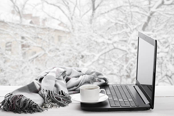 istock Laptop and coffee on winter window 503418474