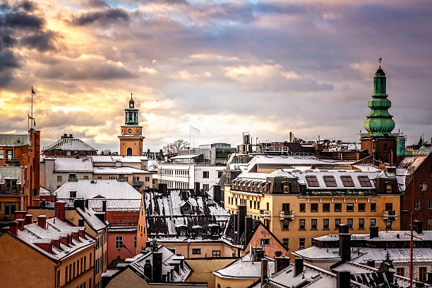 Sunset over Roofs Winter sunset over snow covered old buildings roofs, Stockholm, Sweden. sodermalm photos stock pictures, royalty-free photos & images