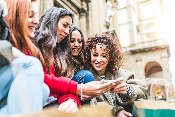 istock Young Friends Using Mobile Phone Together While Shopping 503422504