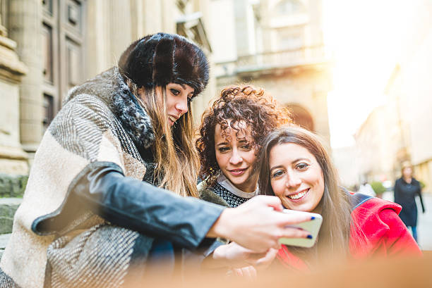 istock Young Friends Using Mobile Phone Together While Shopping 503424474