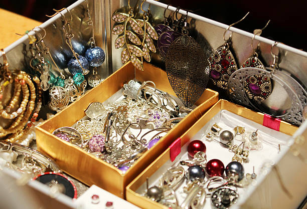 Box full of women's jewelry and earrings stock photo