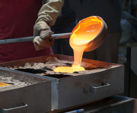 Molten glass poured from ladle into mould