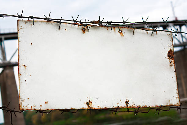 istock White plate on a fence with barbed wire 503437027
