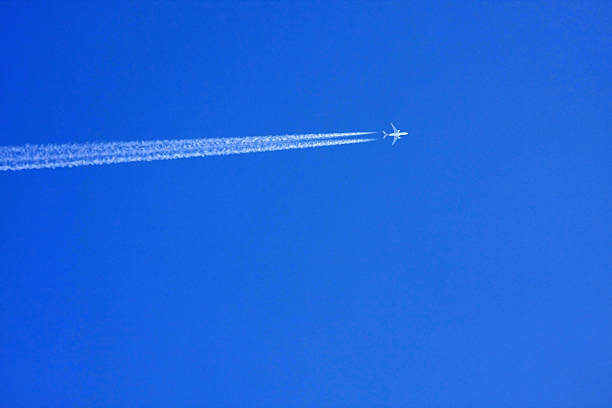 istock airplane contrail against clear blue sky 503437443