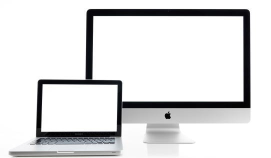 İstanbul, Turkey - July 22, 2014 : Apple iMac 27 inch desktop computer and Macbook Pro on white background. Computers displaying blank white screen and produced by Apple Inc.