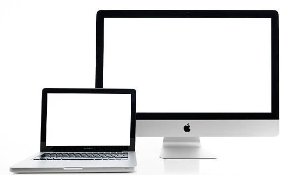 iMac and Macbook İstanbul, Turkey - July 22, 2014 : Apple iMac 27 inch desktop computer and Macbook Pro on white background. Computers displaying blank white screen and produced by Apple Inc. apple computers photos stock pictures, royalty-free photos & images