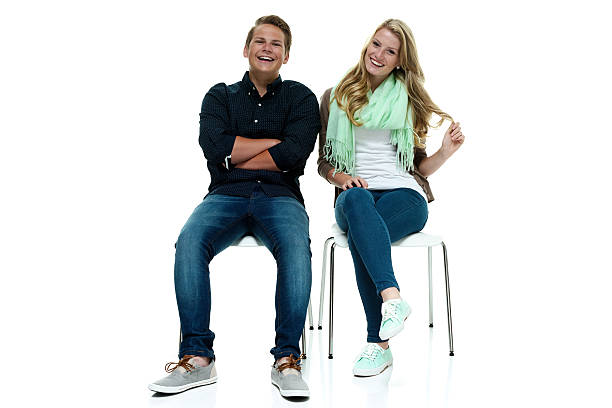 istock Cheerful couple sitting on chair & looking at camera 503438649