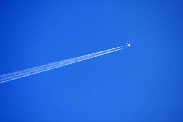 istock airplane contrail against clear blue sky 503438957