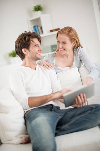 istock cheerful couple watching a digital tablet 503439683