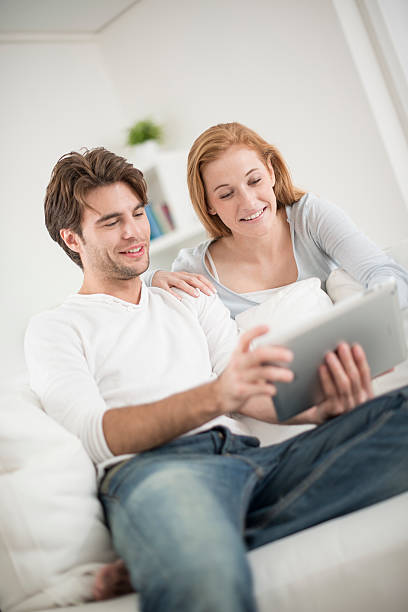 istock cheerful couple watching a digital tablet 503439685