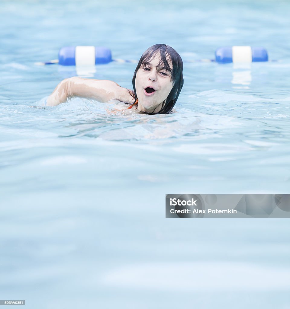 Early teenager girl swimming in the swimming pool Bikini Stock Photo