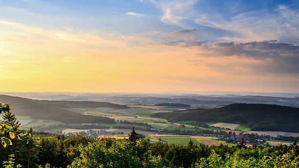 Countryside Summer Sunset Landscape Idyllic Bavarian Rural Countryside Summer Landscape. Picturesque Hills in Upper Franconia, Germany. Villages and rocky terrain at the jurassic mountains with green forrest franconia photos stock pictures, royalty-free photos & images