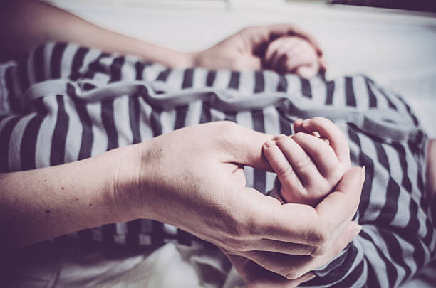 istock Mother holding baby hands 503455358