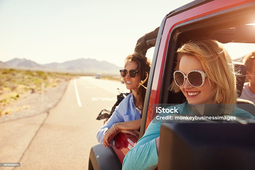 Female Friends On Road Trip In Back Of Convertible Car Back Seat Stock Photo