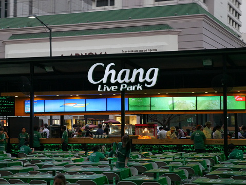 Bangkok, Thailand – December 10, 2015: View of Chang Beer Garden in front of the Central World Shopping Mall in Bangkok. People are in the area. Some staff prepare the service to welcome customers. 