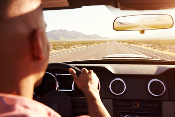 istock Man In Convertible Car Driving Along Open Road 503456238