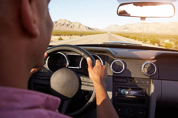 istock Man In Convertible Car Driving Along Open Road 503456332
