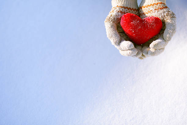 Close-up of hands holding a red heart shape