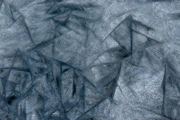 abstract painting made by frost on ice lake. ice hummocks on the frozen surface of the lake